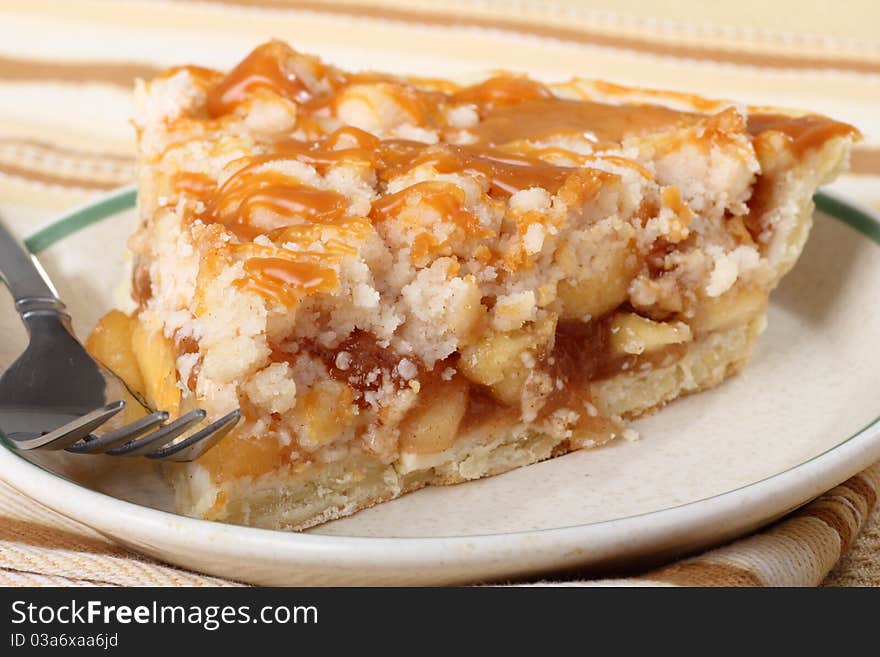 Slice of apple pie topped with caramel