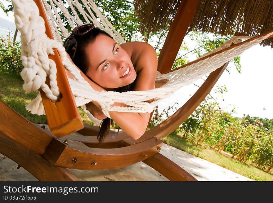 Young woman relaxing in hammock. Young woman relaxing in hammock