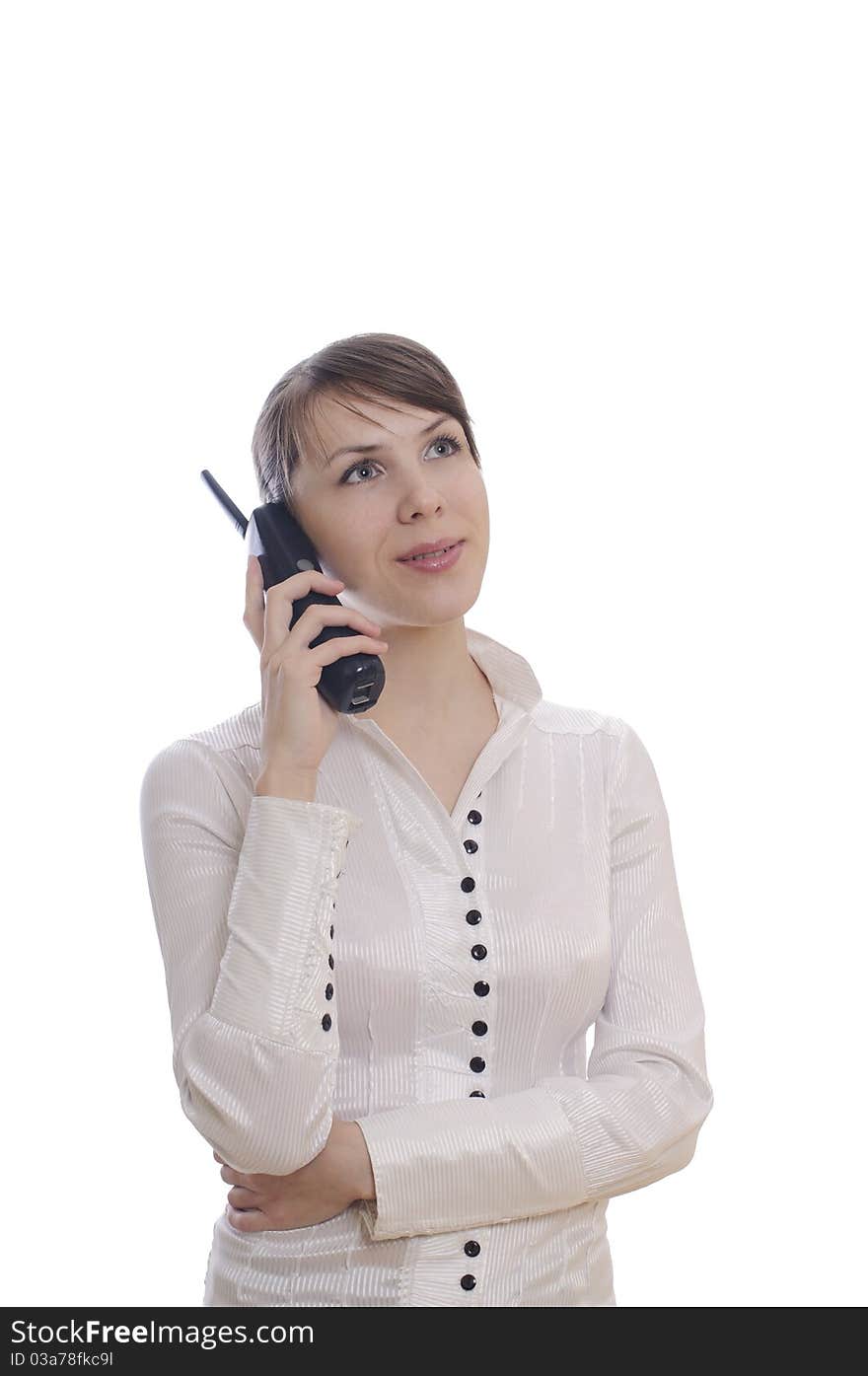 Isolated young business woman with a telephone