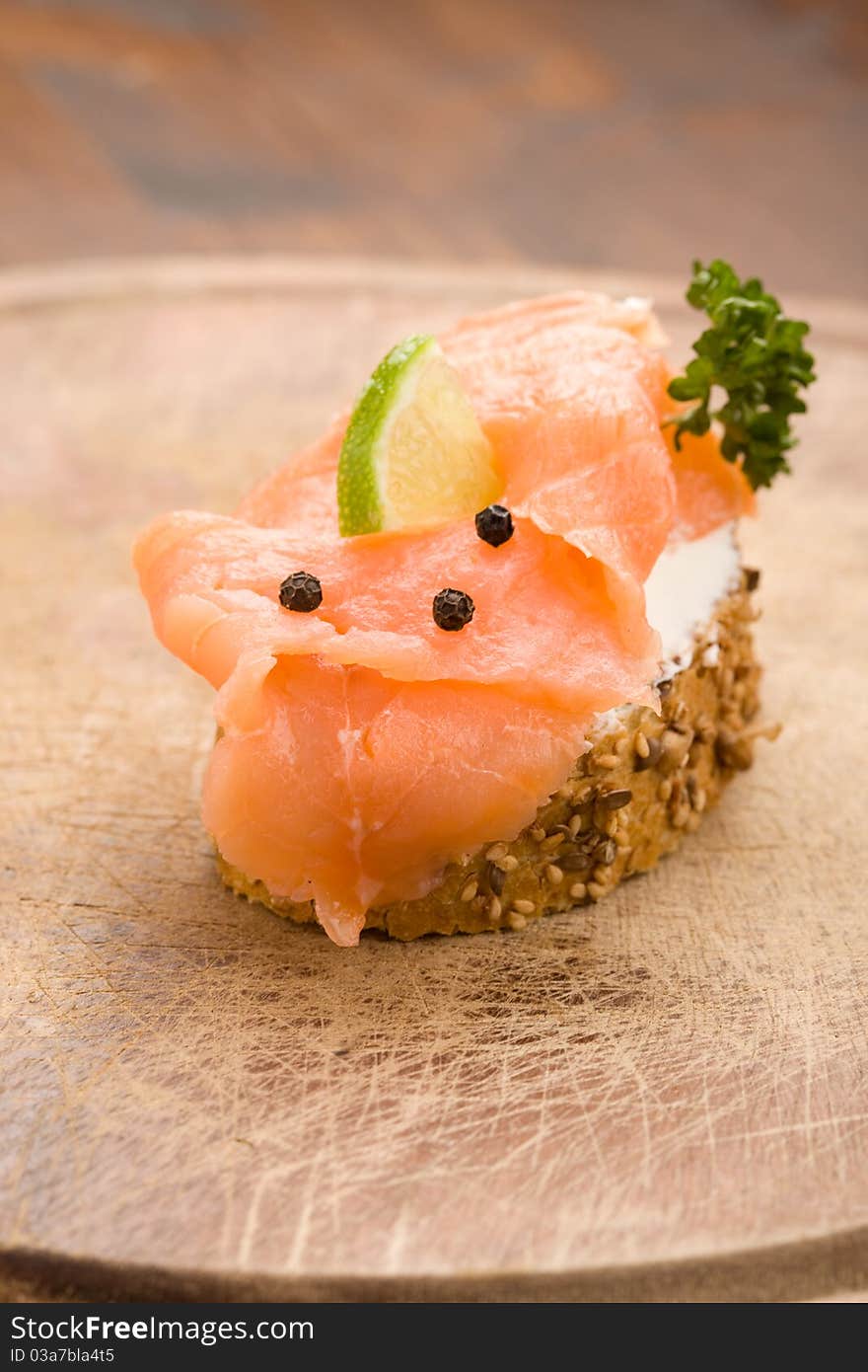 Photo of delicious crispy cereals bread with smoked salmon. Photo of delicious crispy cereals bread with smoked salmon