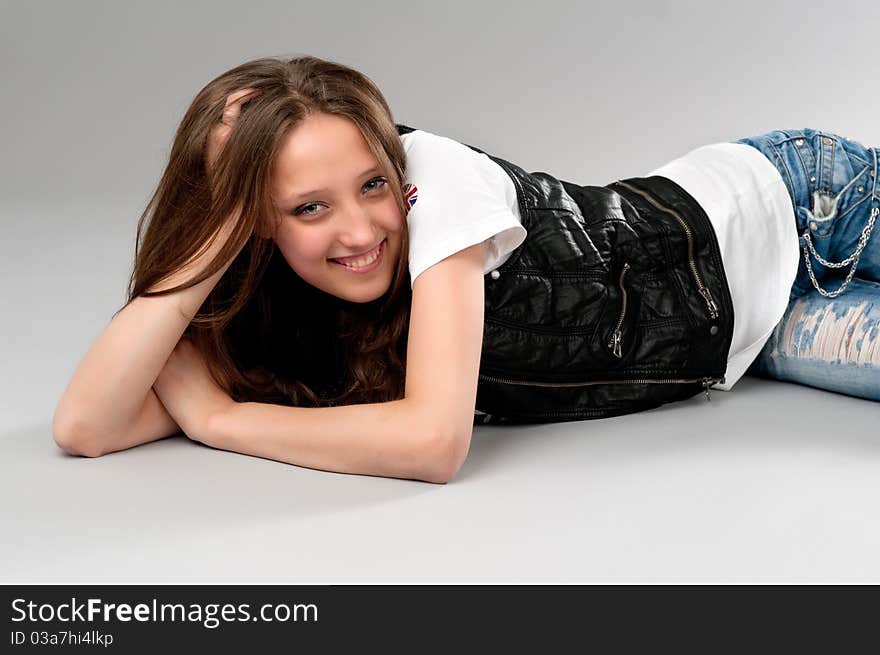 Young happy woman lying on the floor. Young happy woman lying on the floor