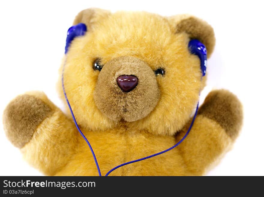 Teddy bear with headphones on his head.