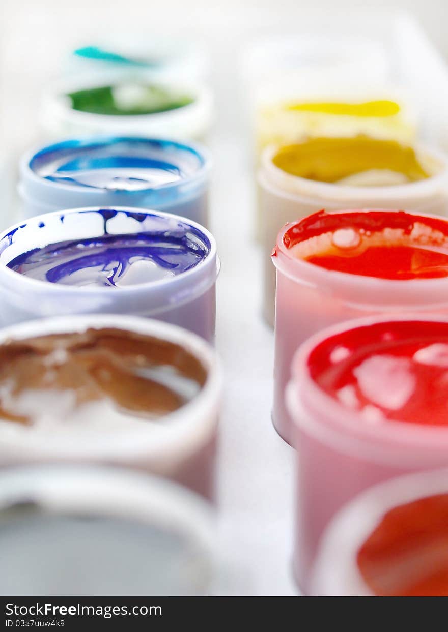 Gouache paints in plastic buckets