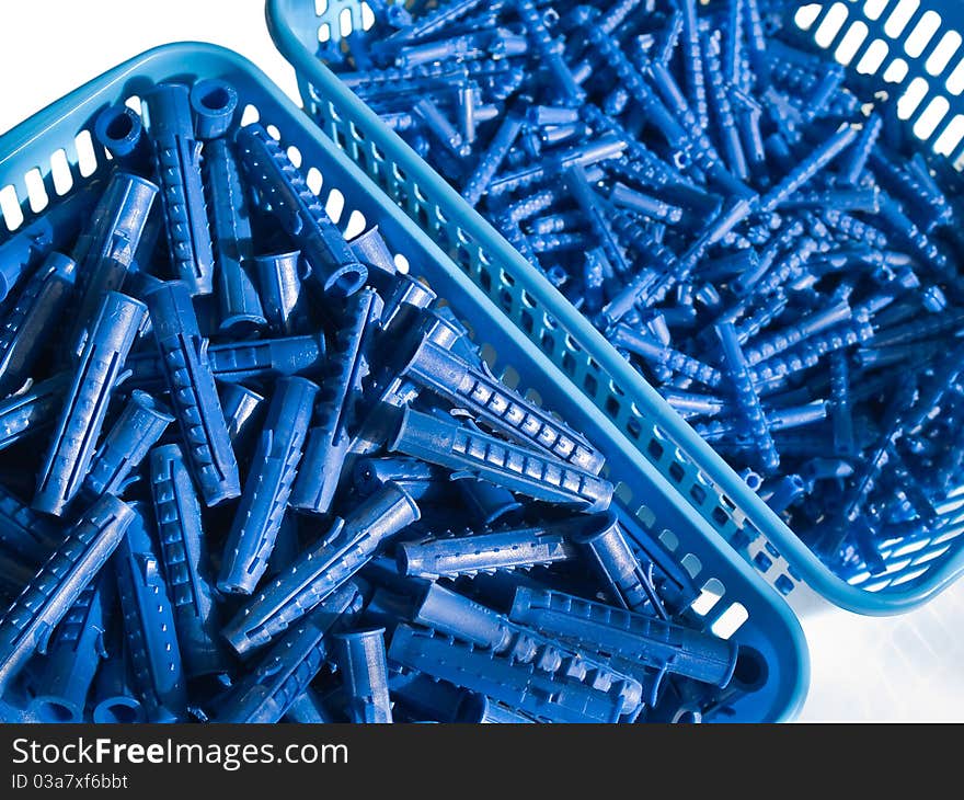 Blue plastic wall plugs in the boxes