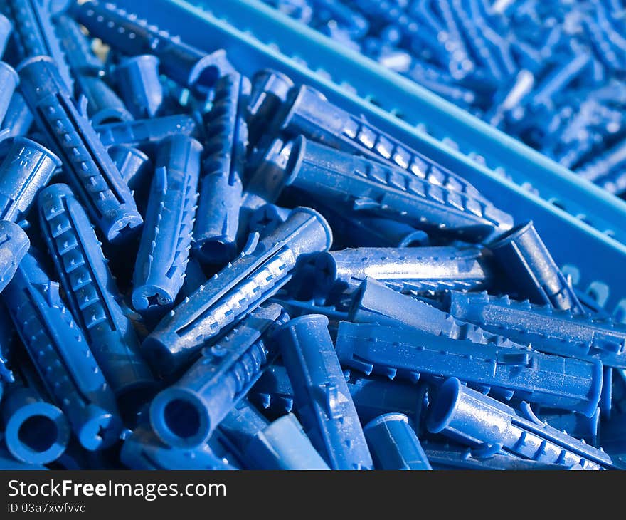 Blue plastic wall plugs in the boxes. Blue plastic wall plugs in the boxes