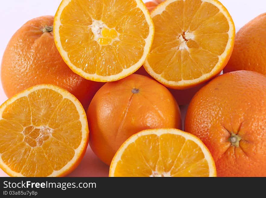 Detail view of a bunch of oranges isolated on a white background.