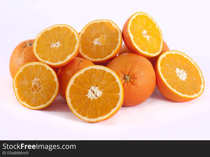 Detail view of a bunch of oranges isolated on a white background.