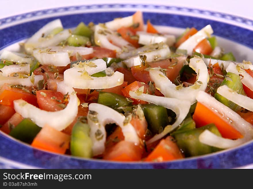 Detail view of a freshmade mediterranean salad isolated on a white background. Detail view of a freshmade mediterranean salad isolated on a white background.