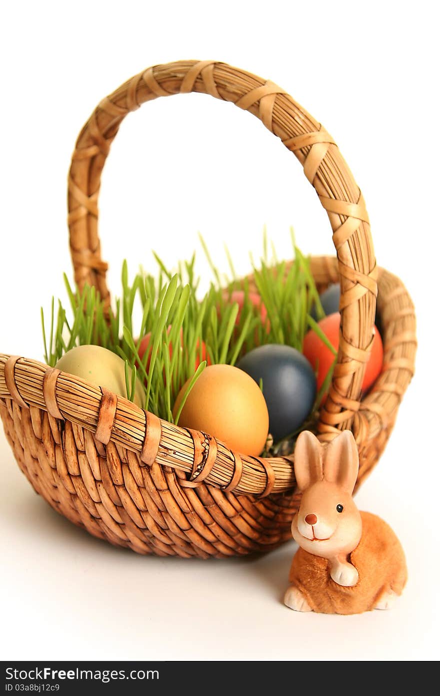 Basket with colored eggs on white. Basket with colored eggs on white