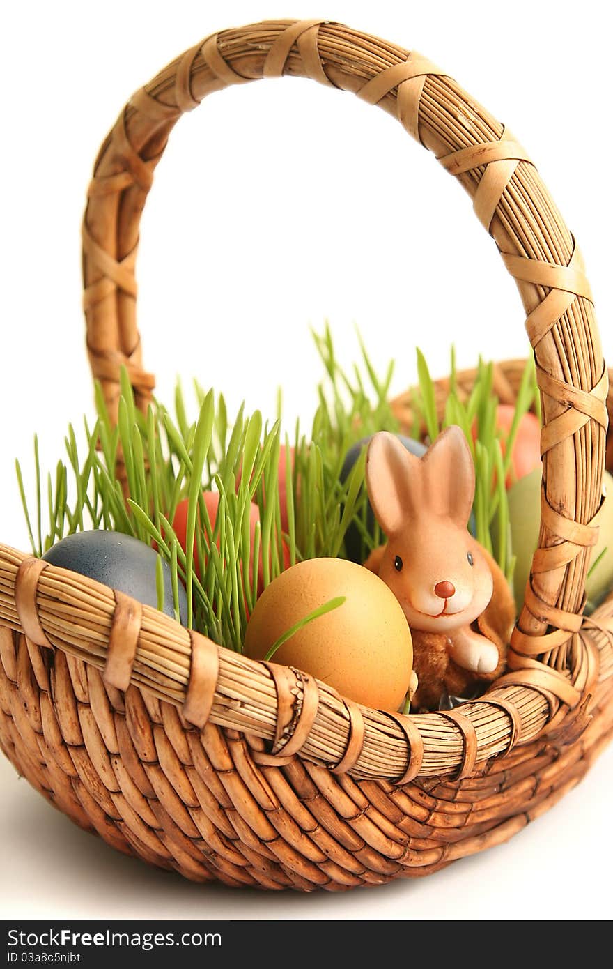 Basket with colored eggs on white. Basket with colored eggs on white