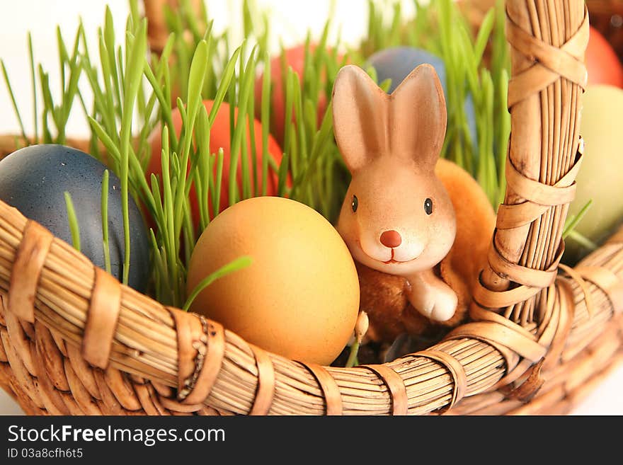 Basket with colored eggs on white. Basket with colored eggs on white