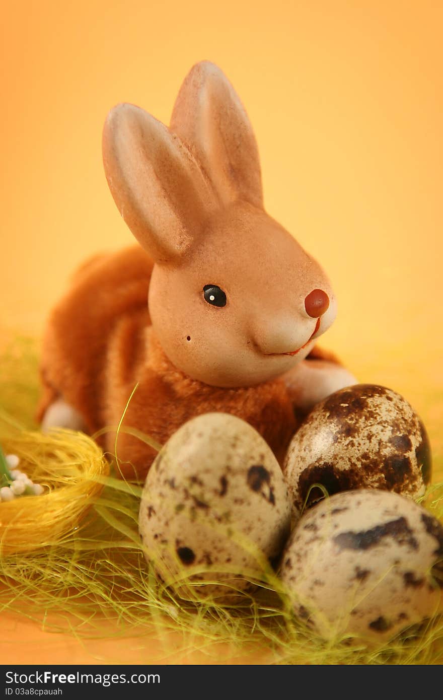 Easter bunny with colored eggs on yellow background. Easter bunny with colored eggs on yellow background