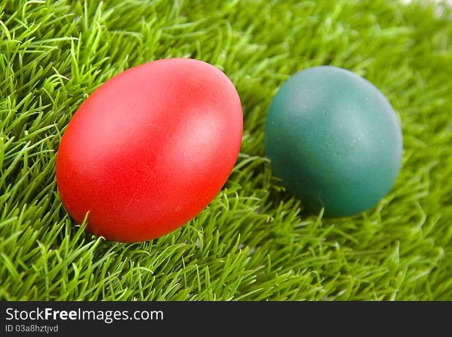 Colorful Easter eggs on green grass