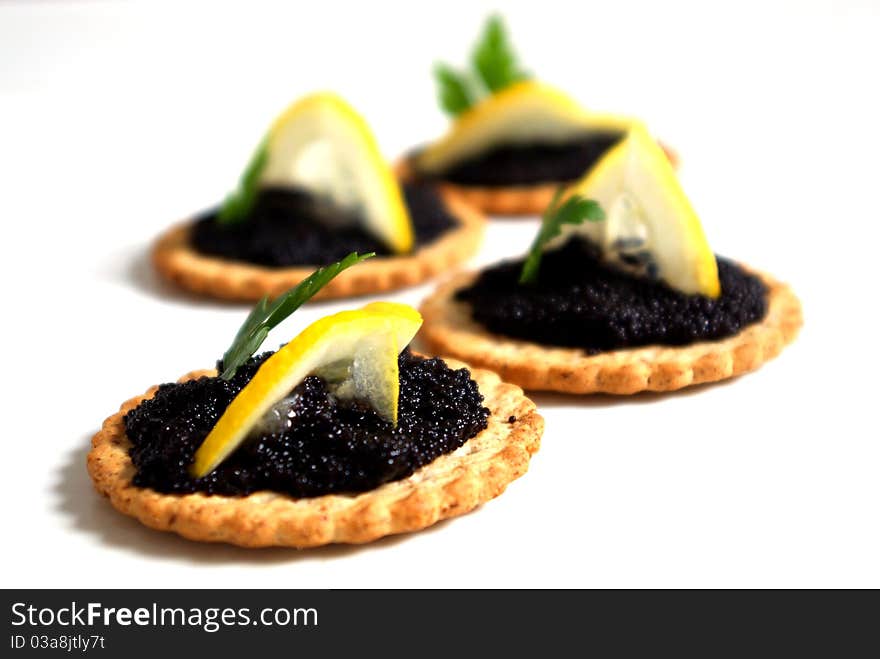 Caviar and lemon on a biscuit