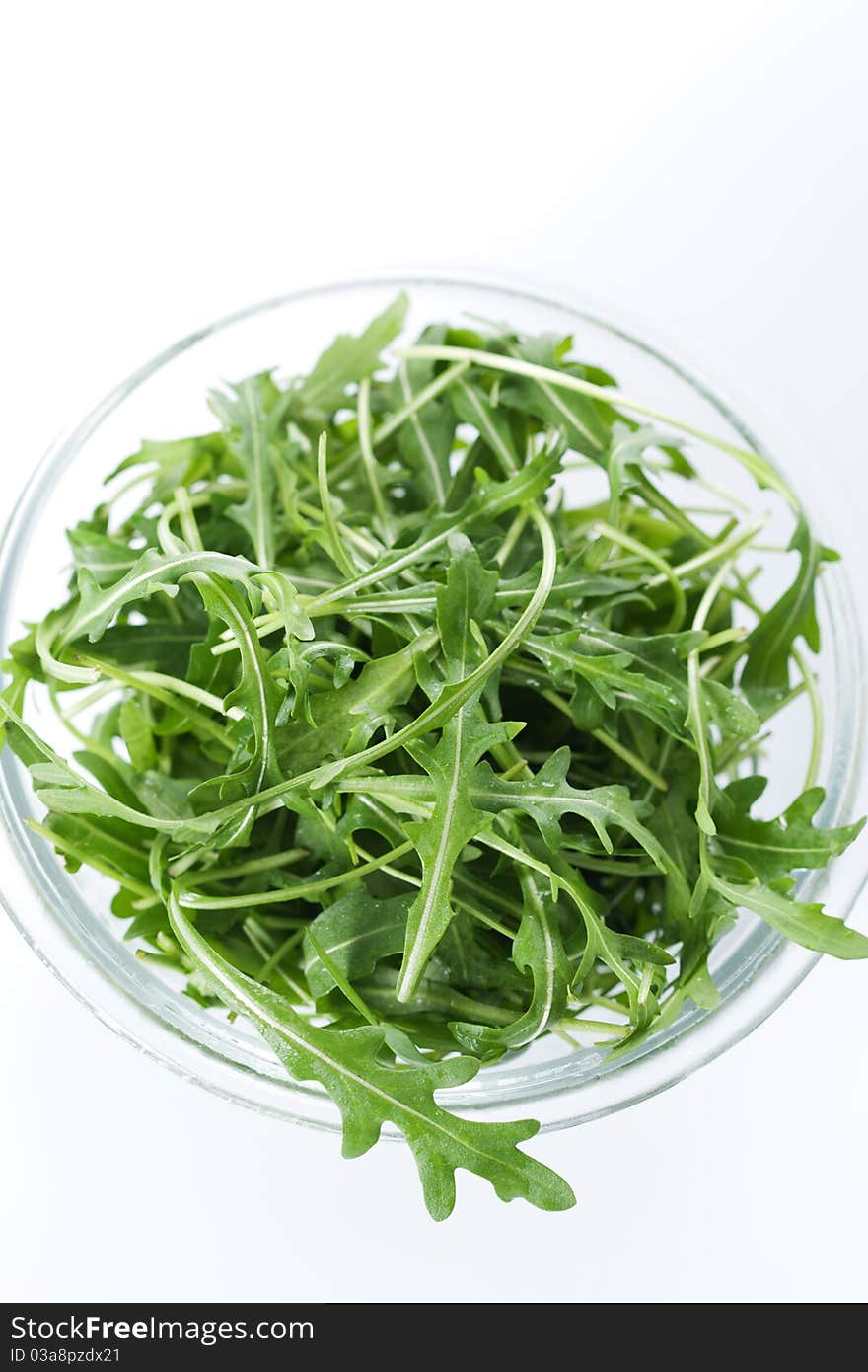 Green rucola fresh salad in glass bowl