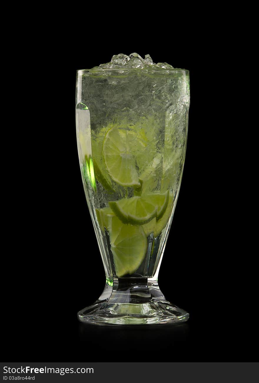 Cocktail with lime and Ice isolation on a black