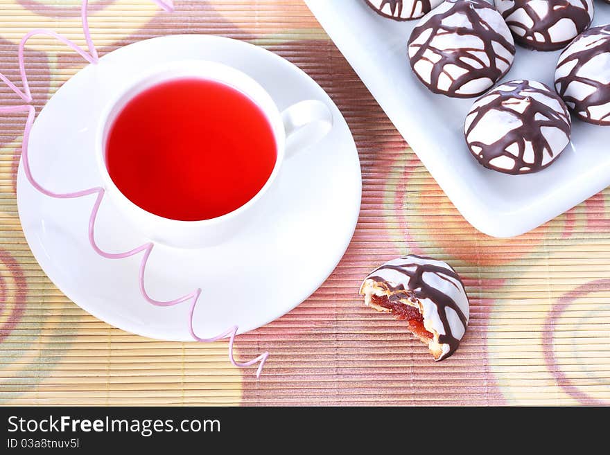 Cup of tea and chocolate decorated spice cakes