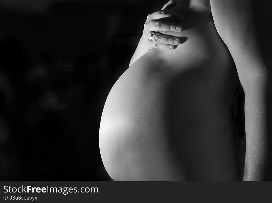 8 month pregnant lady shot on a black background. 8 month pregnant lady shot on a black background