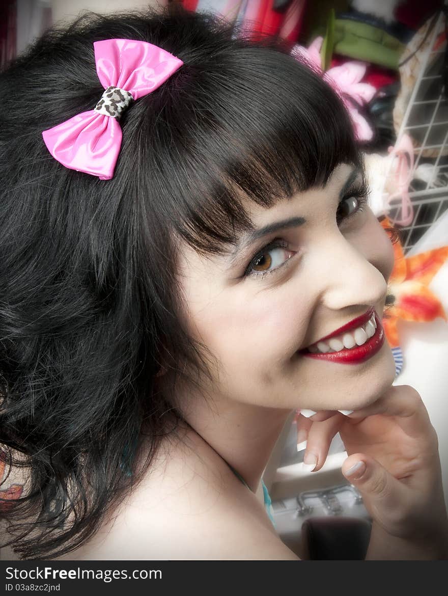 Adorable pinup model wearing pink hair bow