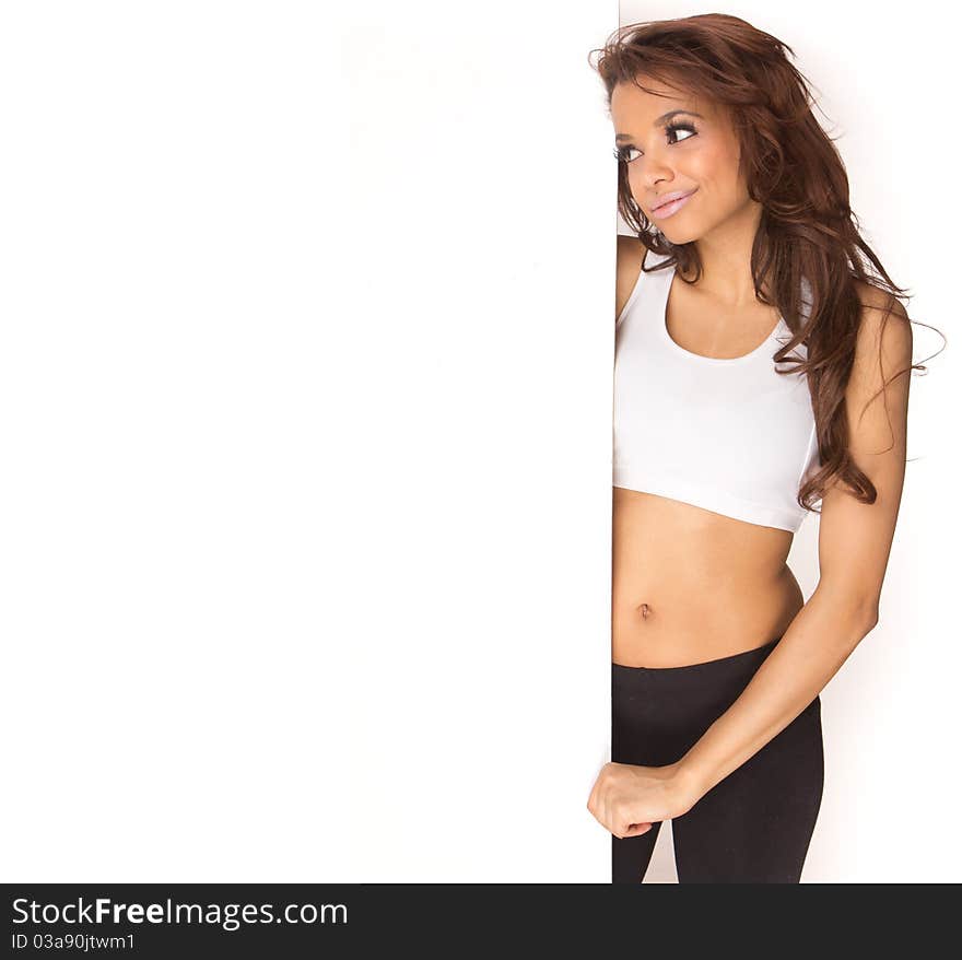 Cute young fitness woman holding a white board