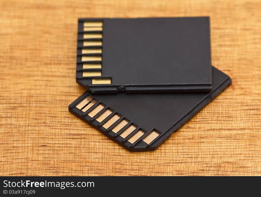 Two black memory cards on wooden table. Two black memory cards on wooden table