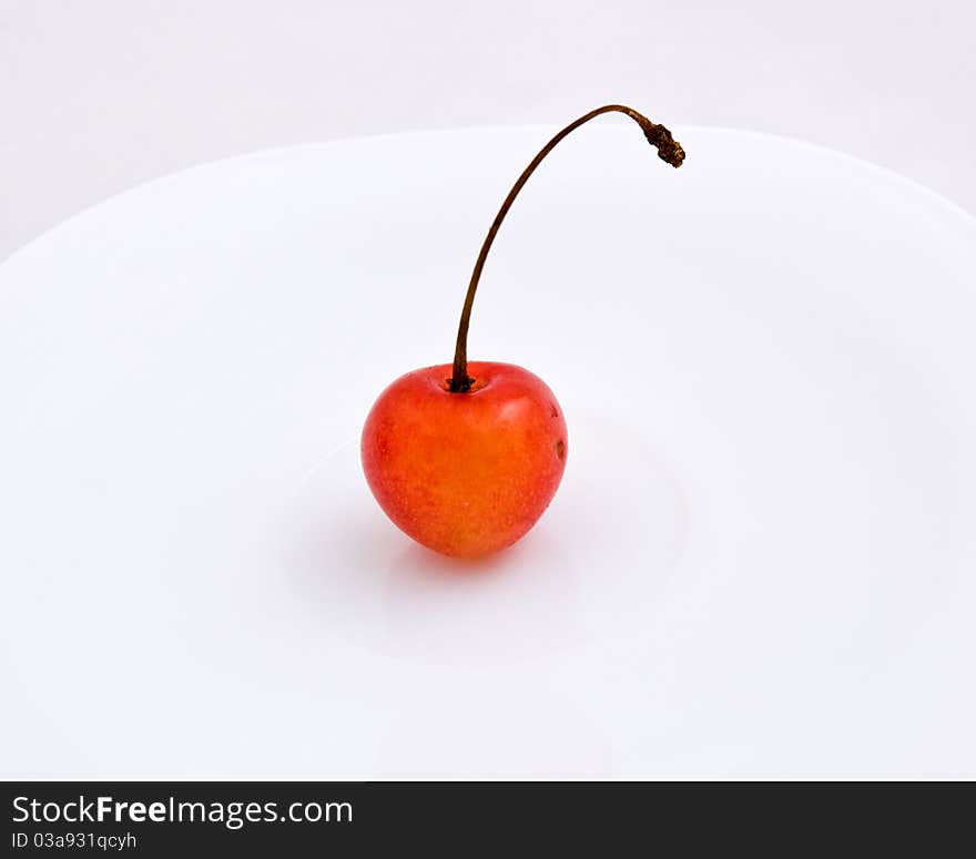 Sweet cherries.One cherries on white plate