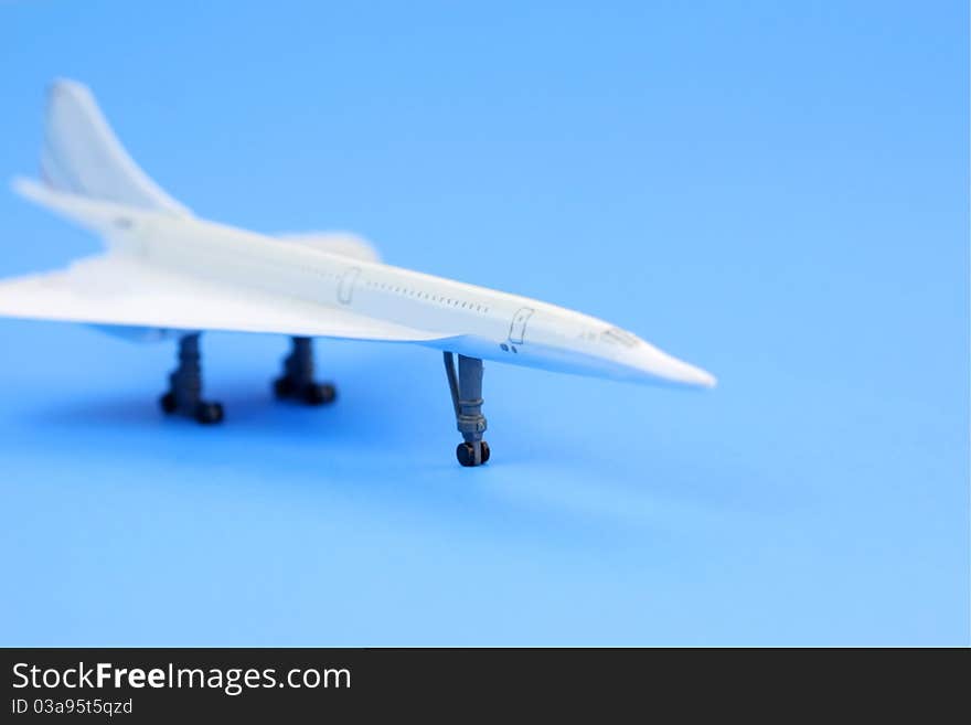 Toy airplane on plain blue background. Toy airplane on plain blue background