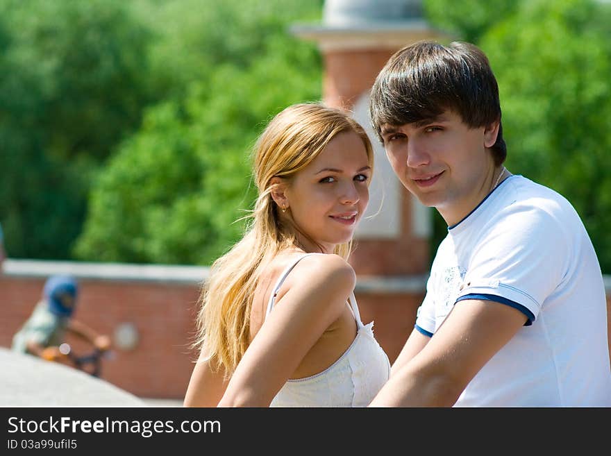 Boy and girl stand facing each other in half a turn to us. Boy and girl stand facing each other in half a turn to us