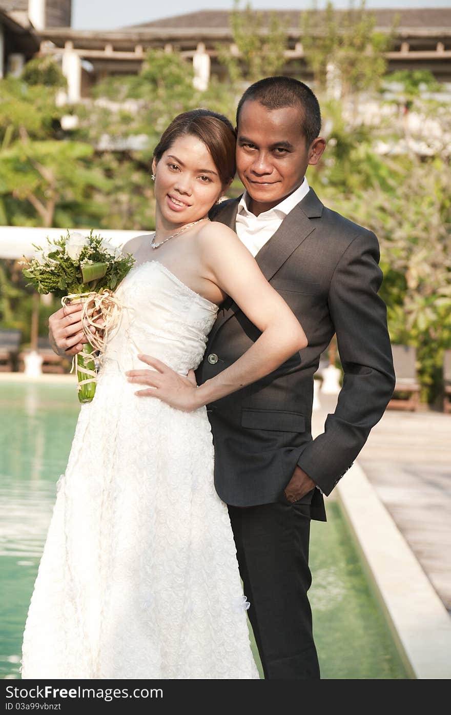 Asian wedding couple in tropical location