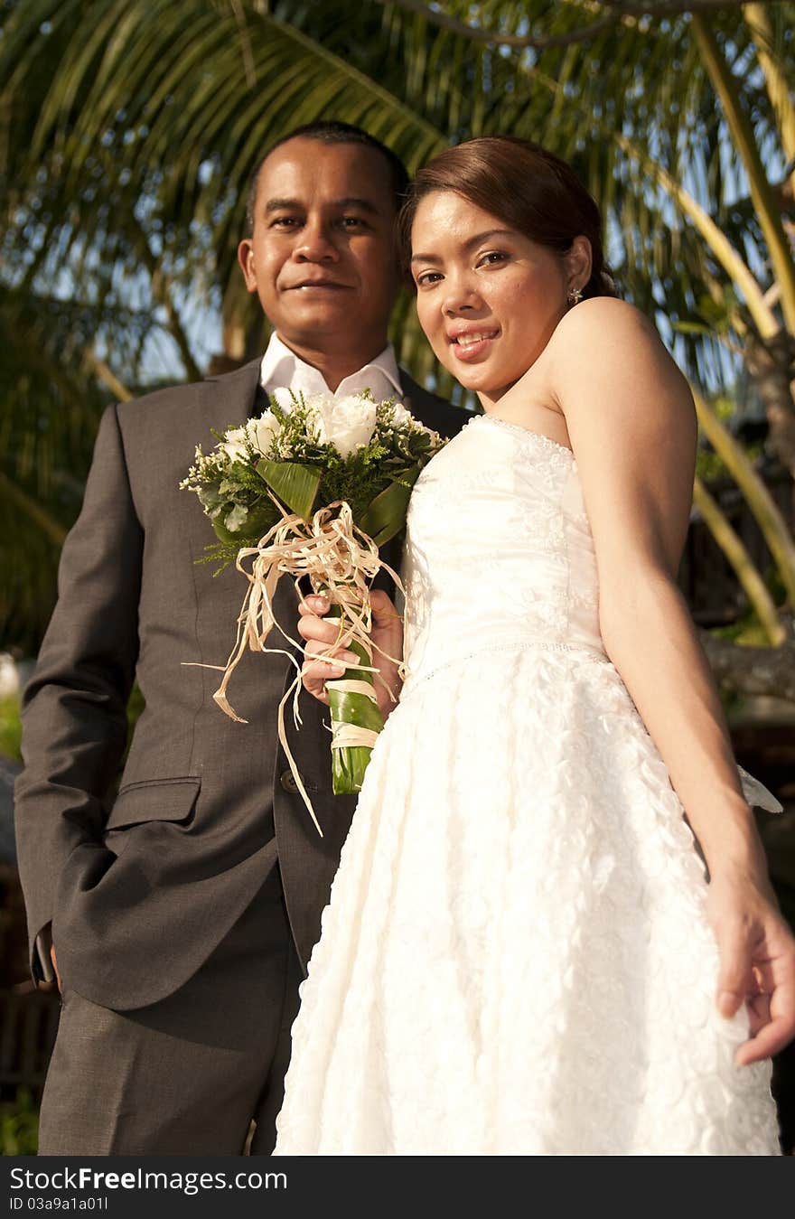 Asian wedding couple in tropical location