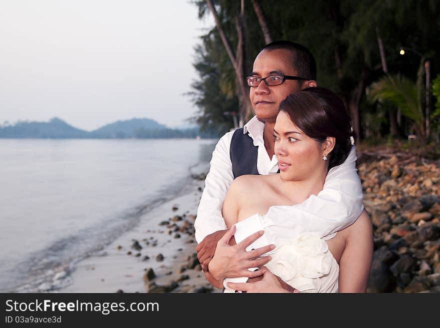 Happy Asian Wedding Couple In Tropical Location