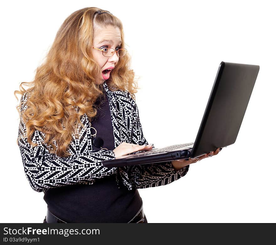 Portrait of a surprised young woman with laptop against white background