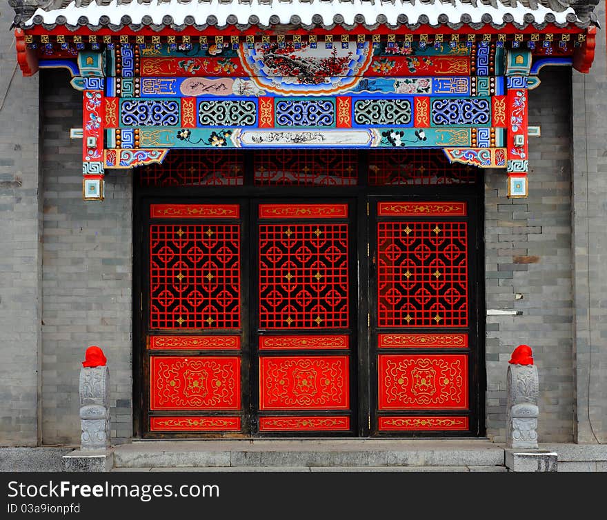 Red Chinese door and covered by snow