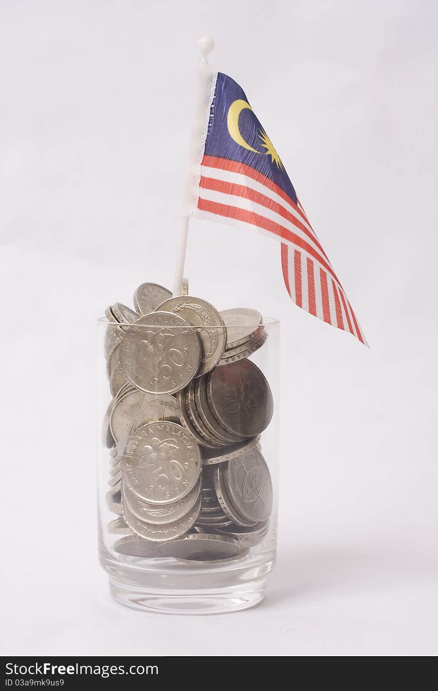 Full glass with a coin isolated a flag. Full glass with a coin isolated a flag