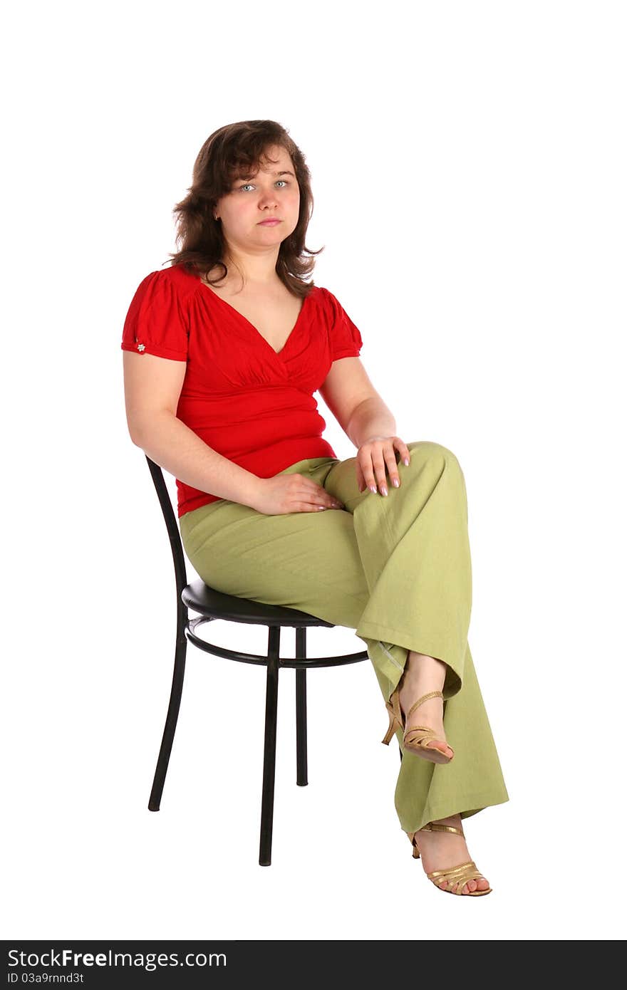 Chubby girl sits on stool. Isolated on white.