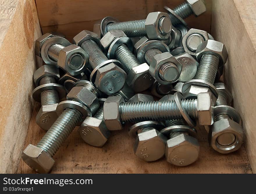 Bolts in the wooden box. Bolts in the wooden box