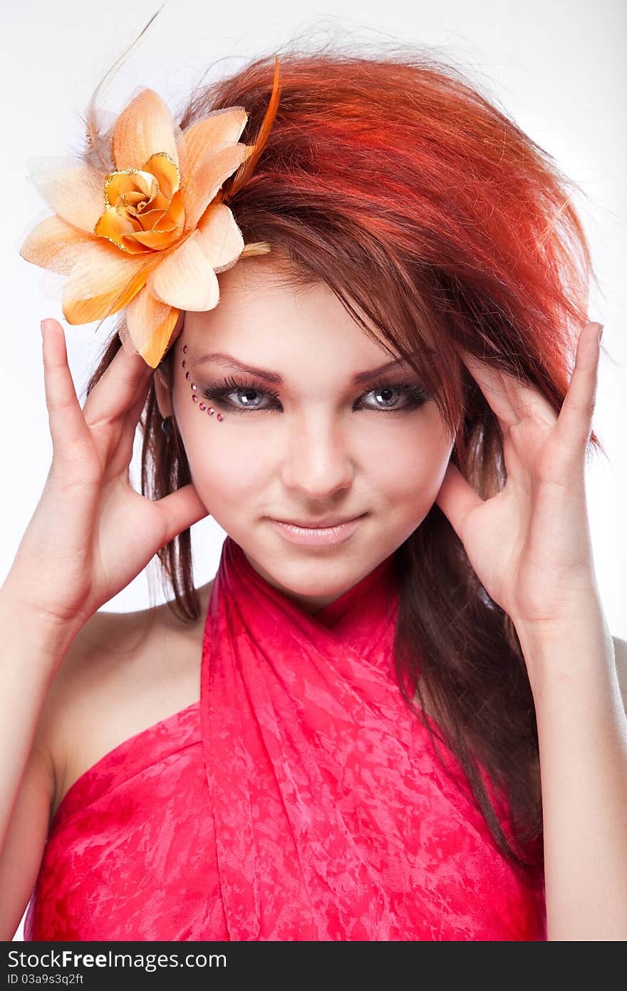 Portrait of woman with flower in hair on white