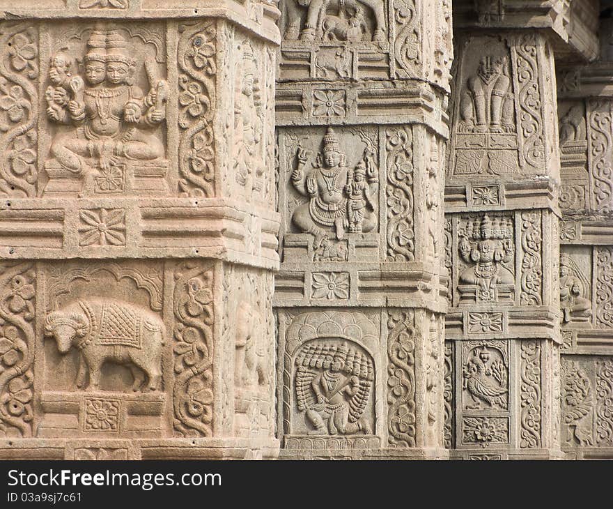 A row of intricately carved columns at a temple entrance. A row of intricately carved columns at a temple entrance