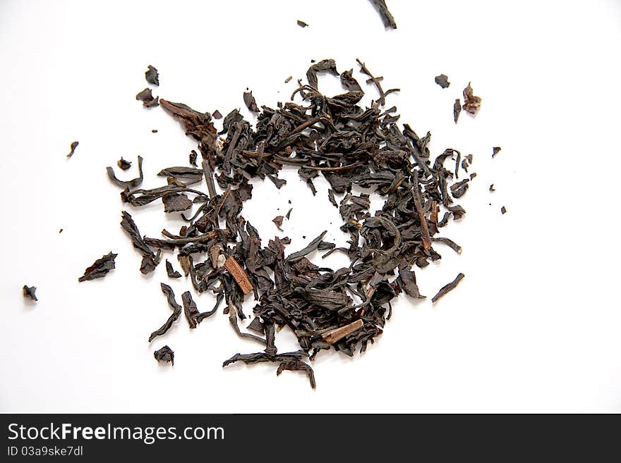 Dried black tea leaves on white background