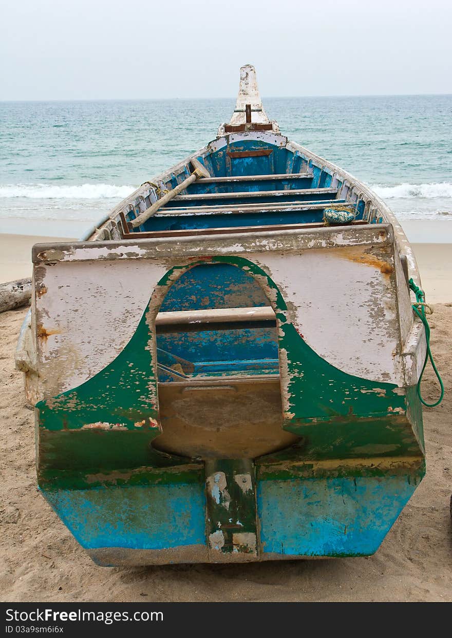 A crusty old fishing boat lying on a beach in Kerala. A crusty old fishing boat lying on a beach in Kerala.