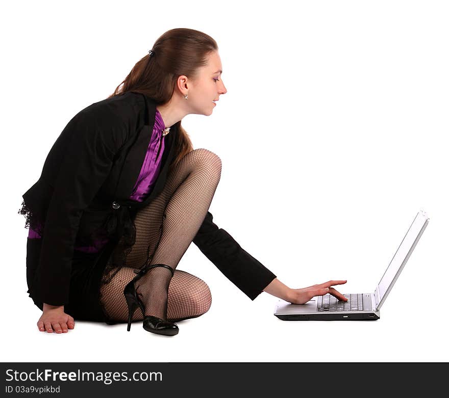 Girl sits on floor and works with notebook.