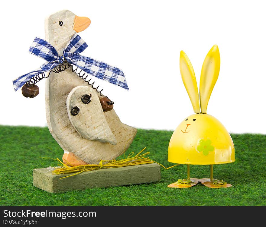 Easter goose and egg-shaped rabbit sitting on the grass. Easter goose and egg-shaped rabbit sitting on the grass