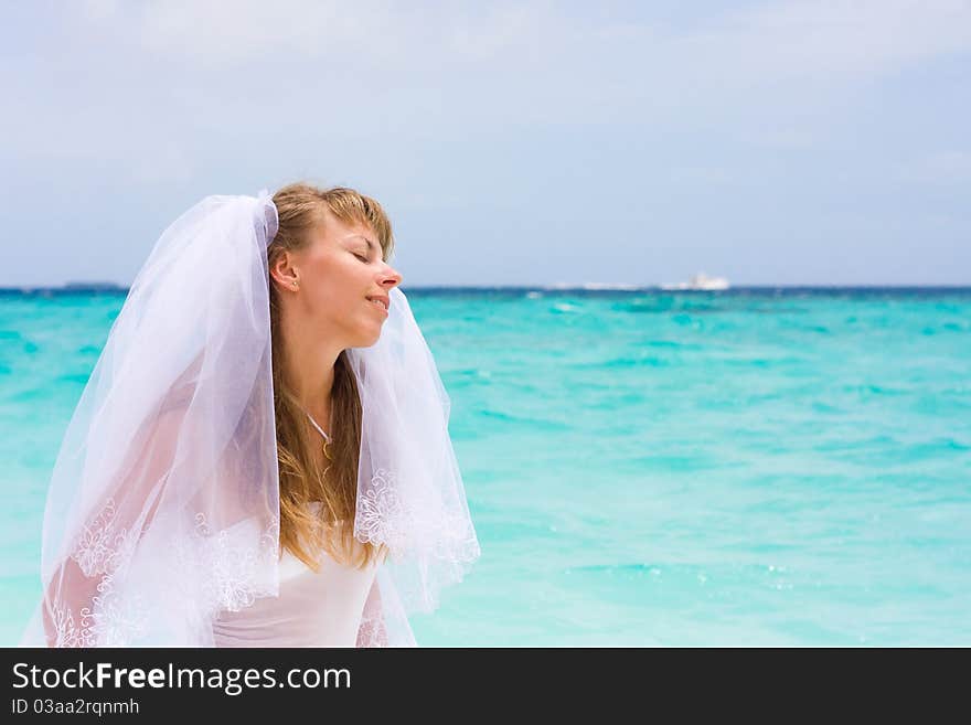 Bride on a coastline at tropical beach. Bride on a coastline at tropical beach