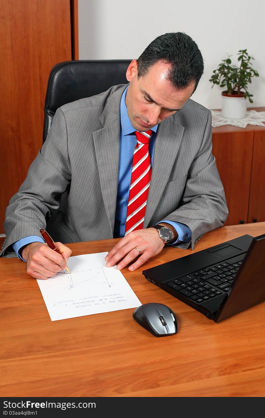 Portrait of handsome successful businessman in his office