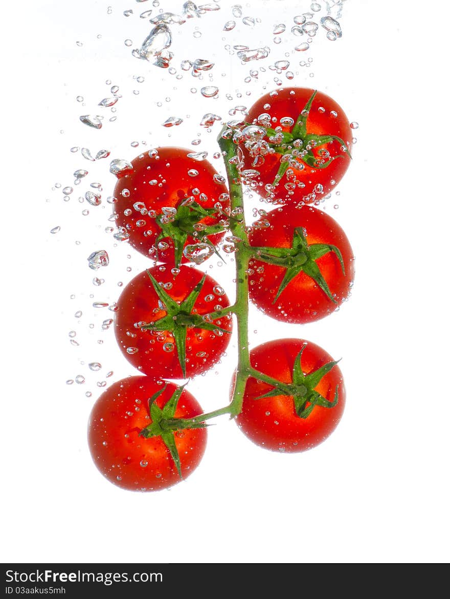 Fresh tomatoes with water bubbles isolated on whit