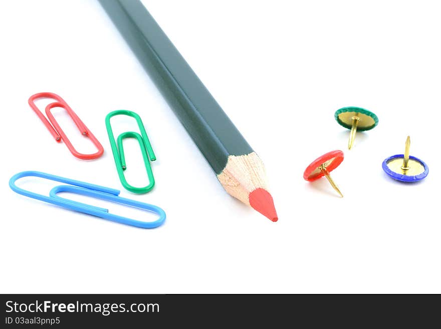 Coloured pencil and paper clips and drawing pins