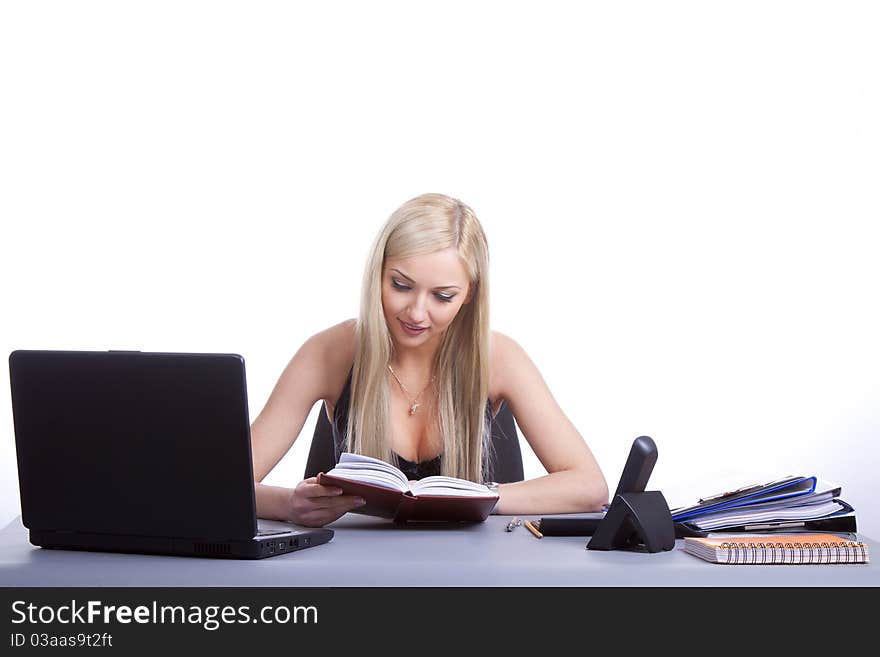 Happy businesswoman sitting at office desk. Isolated on white background. Happy businesswoman sitting at office desk. Isolated on white background.