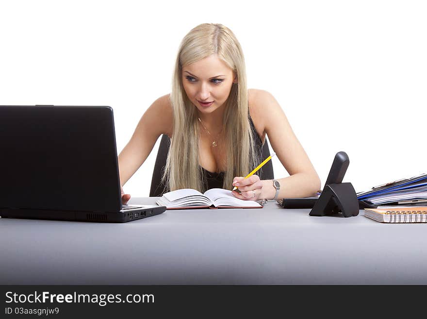 Happy businesswoman sitting at office desk. Isolated on white background. Happy businesswoman sitting at office desk. Isolated on white background.