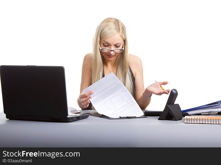 Happy businesswoman sitting at office desk. Isolated on white background. Happy businesswoman sitting at office desk. Isolated on white background.