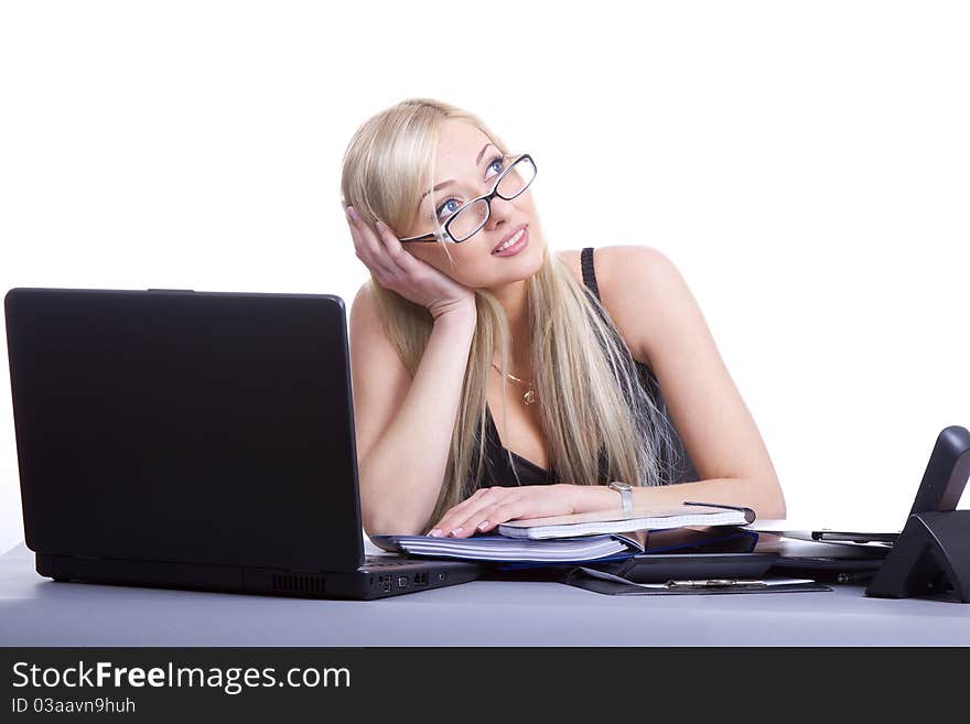 Happy businesswoman sitting at office desk, smiling. Isolated on white background. Happy businesswoman sitting at office desk, smiling. Isolated on white background.